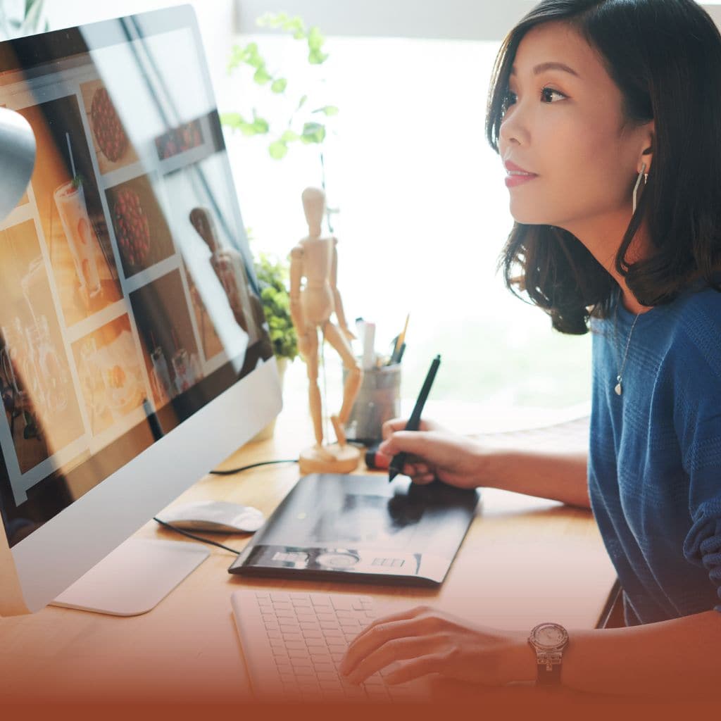 Creatives Services. Oriental woman drawing on tablet, looking at web design on computer