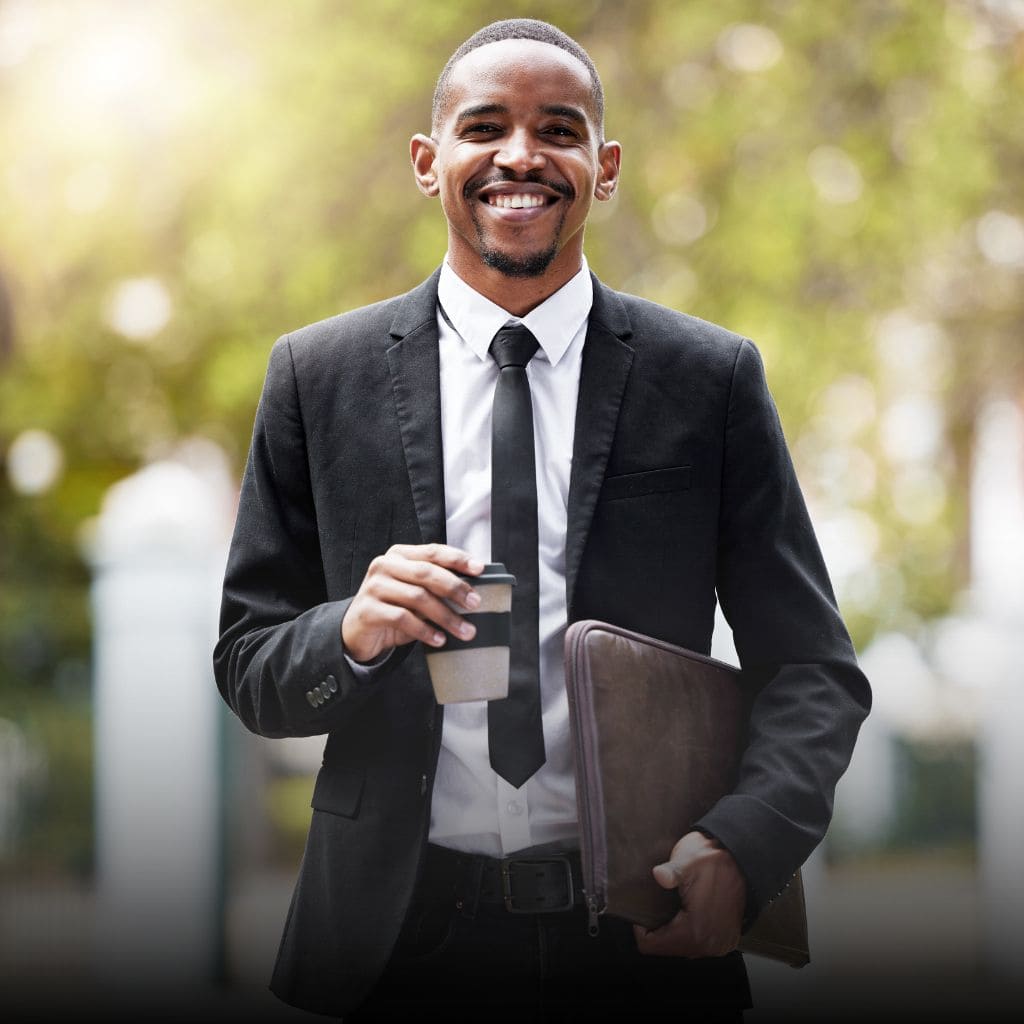 Legal Services Category. Young African American attorney smiling and holding a briefcase.